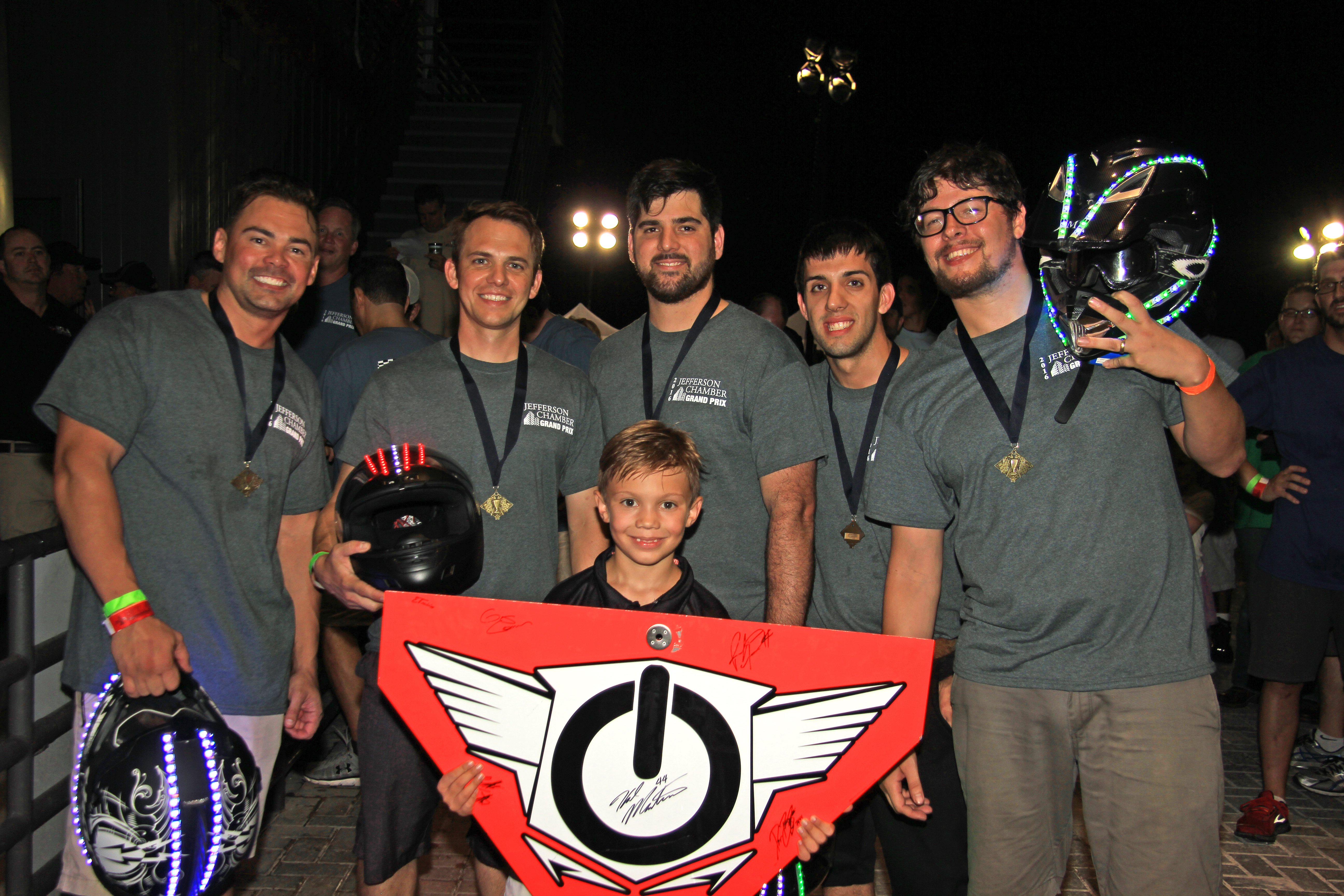 Justin Hartenstein, Danny Talbot, Kirk Jenevein, Stephen Lamana, Patrick Greenfield, and Team Manager Justin Hartenstein Jr. (holding the team logo) representing Oracle Lighting won first place in the Jefferson Chamber of Commerce's 5th annual Grand Prix, Weds. July 13, 2016, at NOLA Motorsports, Avondale, La. (Photo: DJ Ronnie Roux, Snap And Sketch Photo Booths)